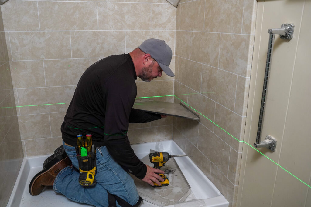 man installing a walk-in shower