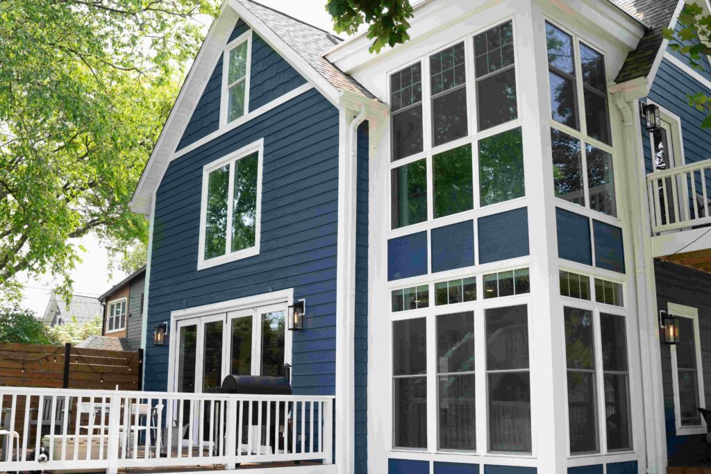 Navy blue house with white window frames and trim